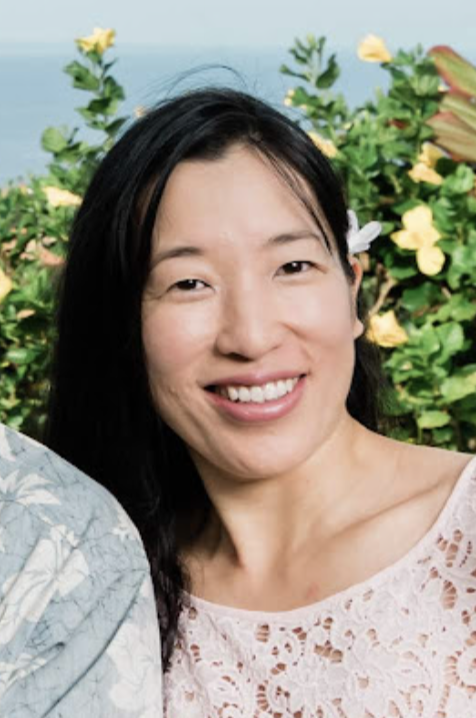 a head and shoulders photo of Reiki Master-Teacher Crystal smiling in a pastel pink lace top